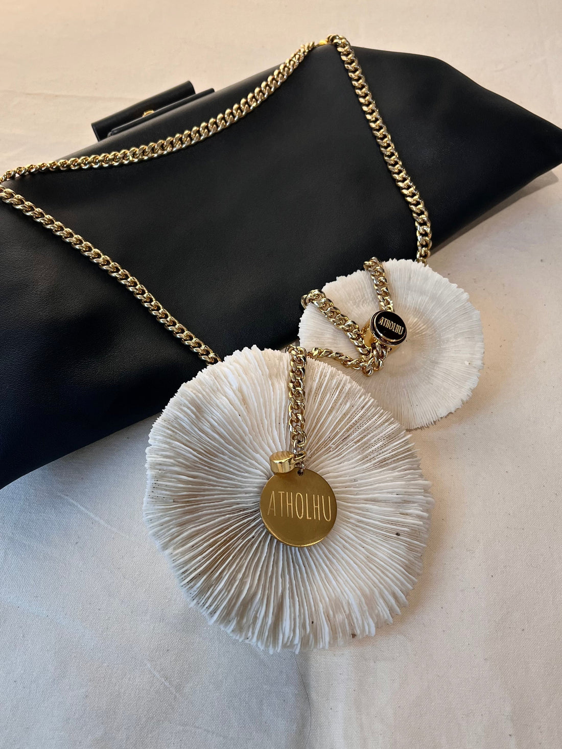 ATHOLHU bag hardware detail — stainless steel clasp, chain strap, gold hardware on leather bag