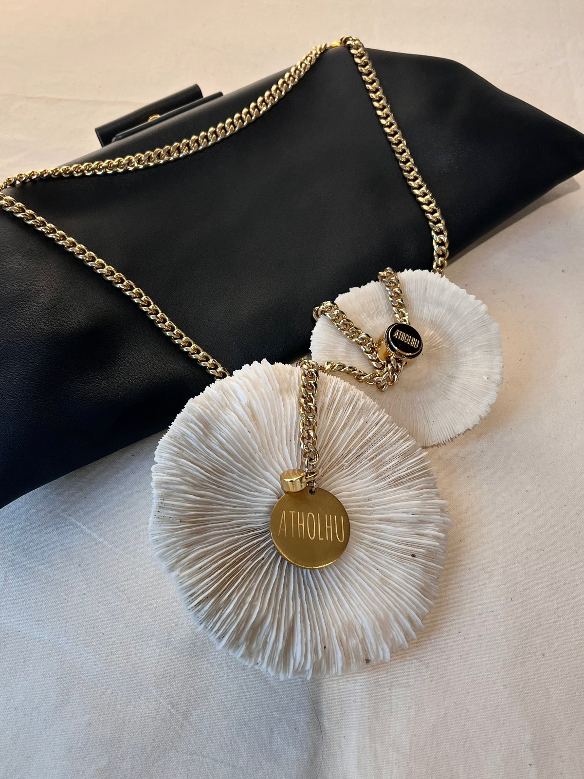 ATHOLHU bag hardware detail — stainless steel clasp, chain strap, gold hardware on leather bag